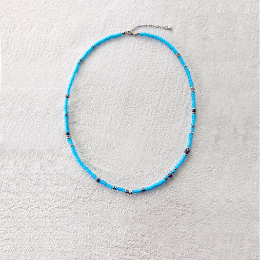 Blue glass beads with silver accents, creating a vibrant and breezy summer look