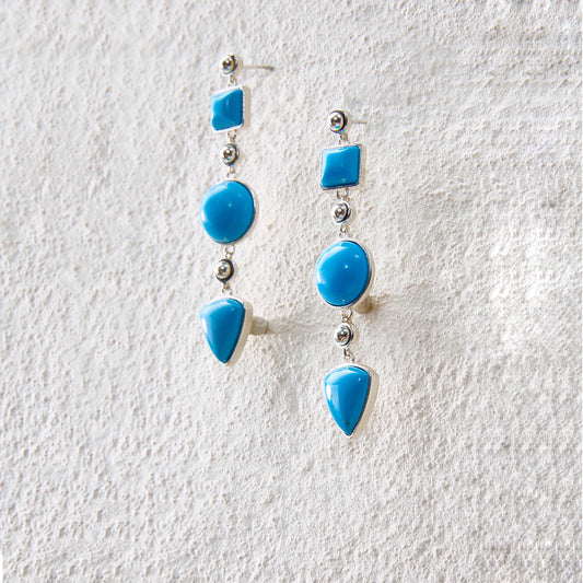 Long drop earrings with turquoise geometric motifs, blending tribal essence and modern aesthetics