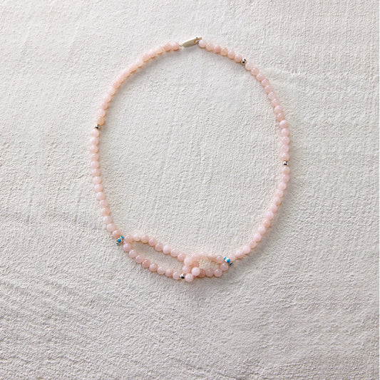 A gentle-toned necklace made of blush pink aventurine, radiating a soft and graceful charm