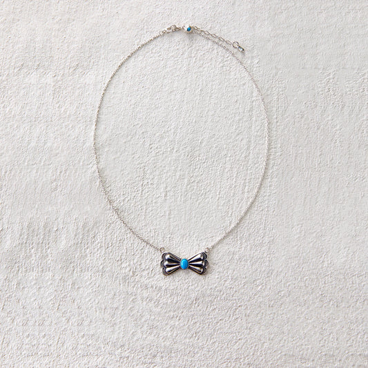 Vintage-style silver bead necklace with butterfly charm and turquoise