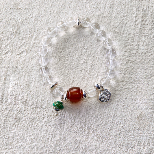 Bracelet featuring clear quartz beads with carnelian and turquoise charms
