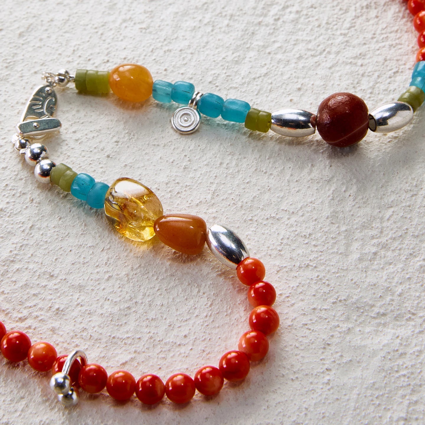 Beaded necklace combining red agate with multicolored gemstones for a vibrant, natural look