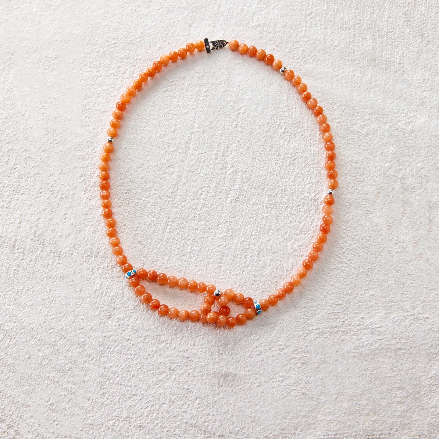 Beaded necklace made of red jasper, featuring a double-loop knot design