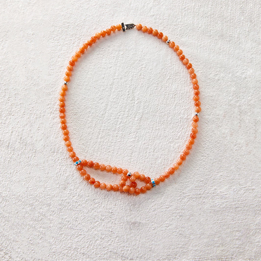 Beaded necklace made of red jasper, featuring a double-loop knot design