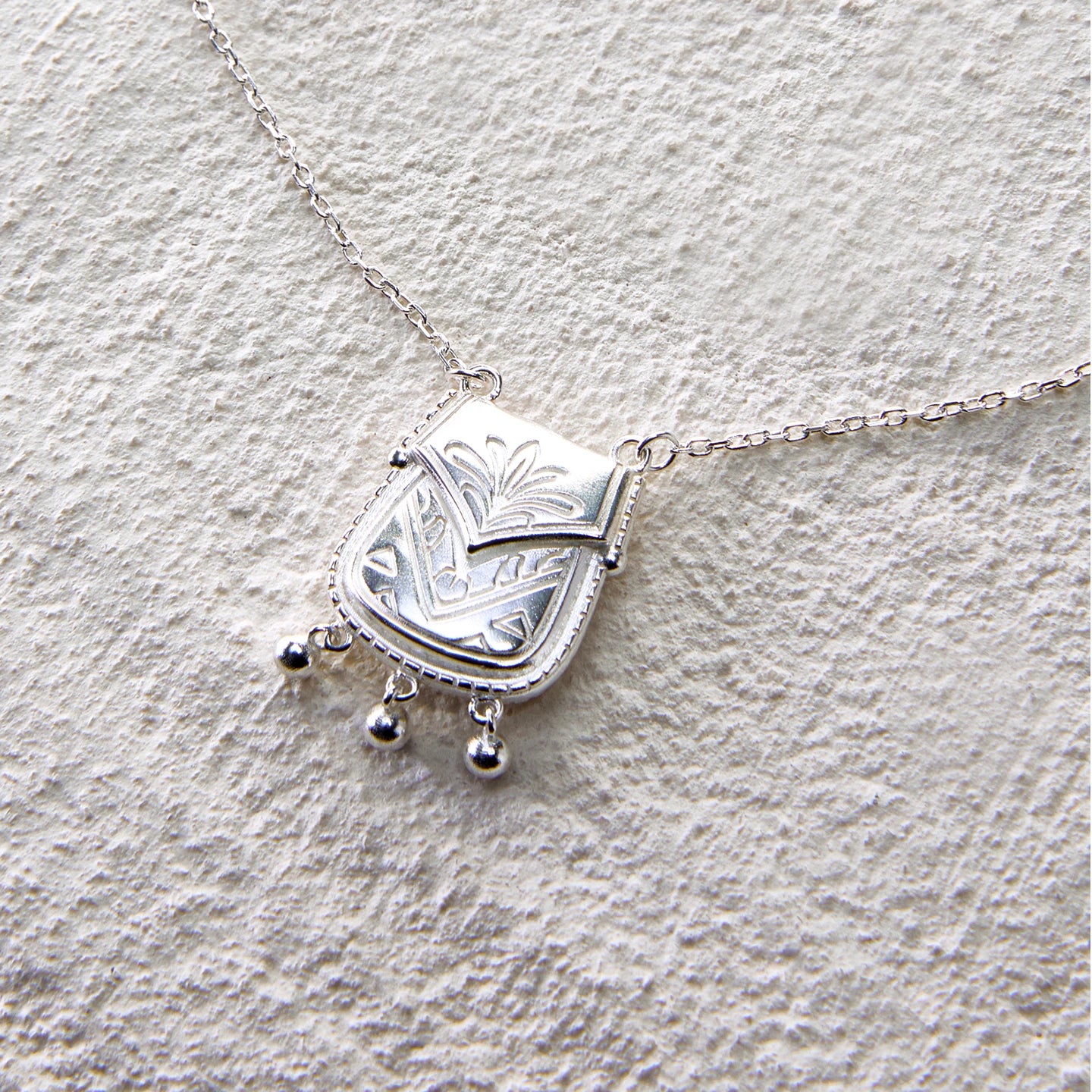 925 silver pouch necklace with floral carvings and dangling beads
