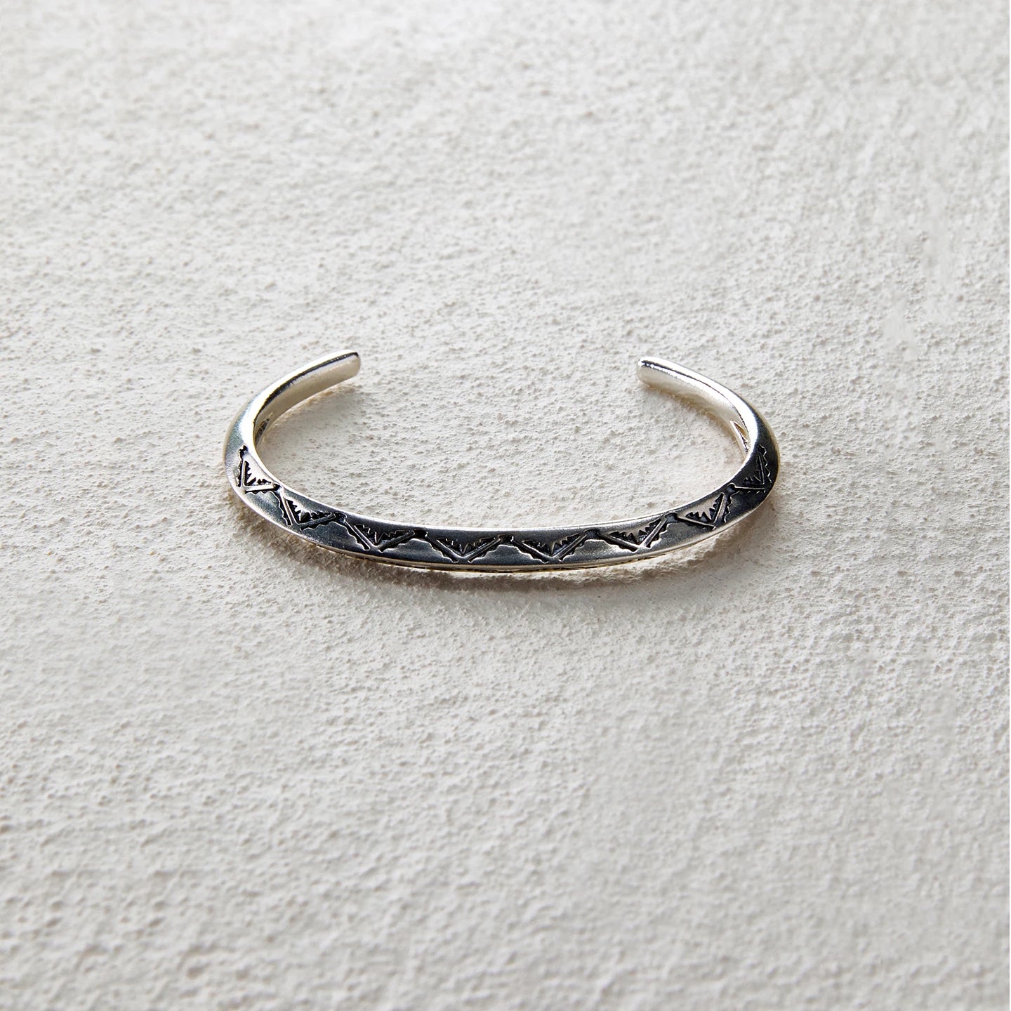 Sterling silver open cuff engraved with mountain ridge motifs