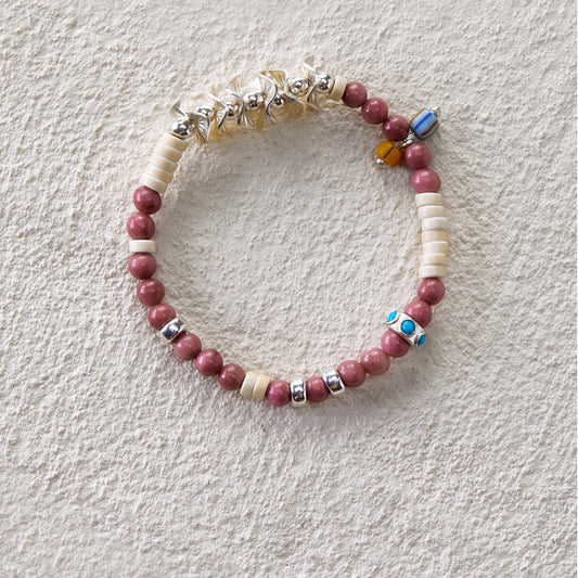 Bracelet featuring rhodochrosite, white turquoise, and glass beads