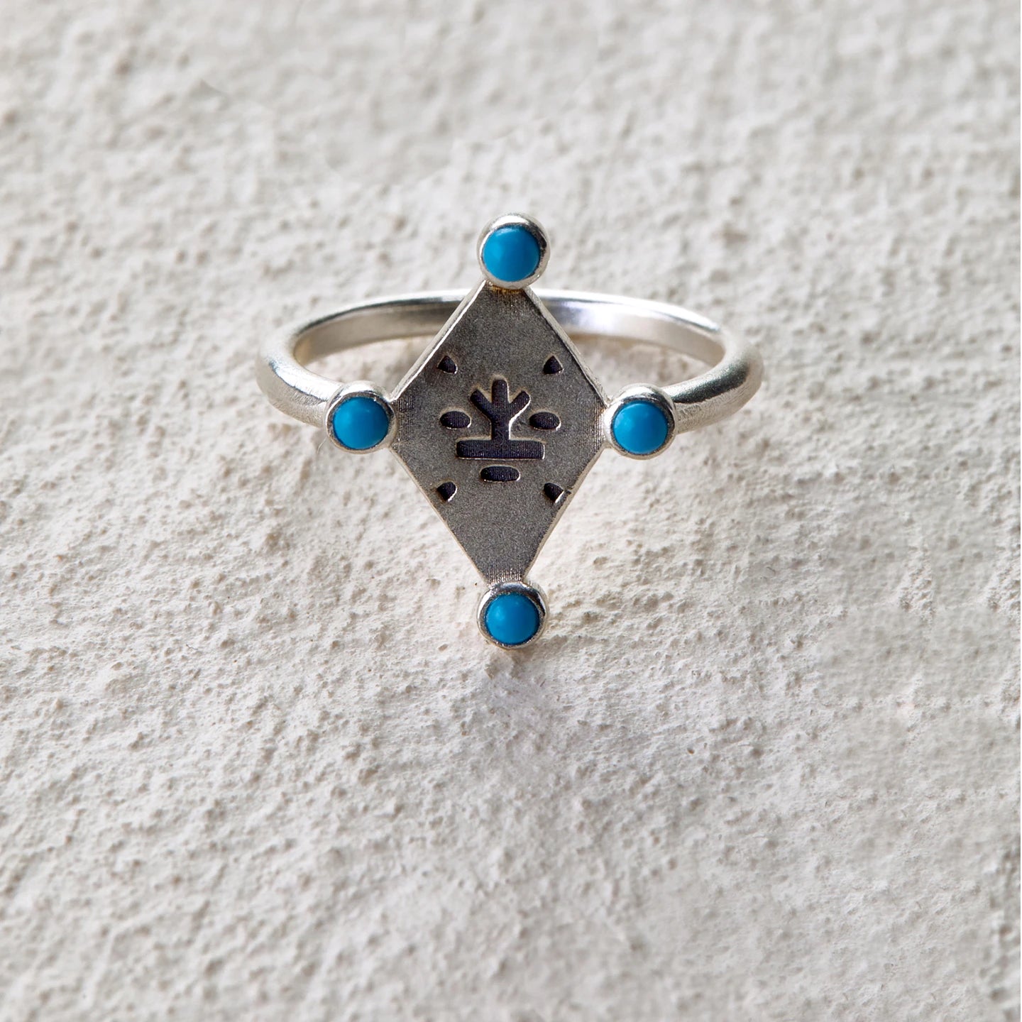 Silver ring with tree totem engraving and four turquoise inlays