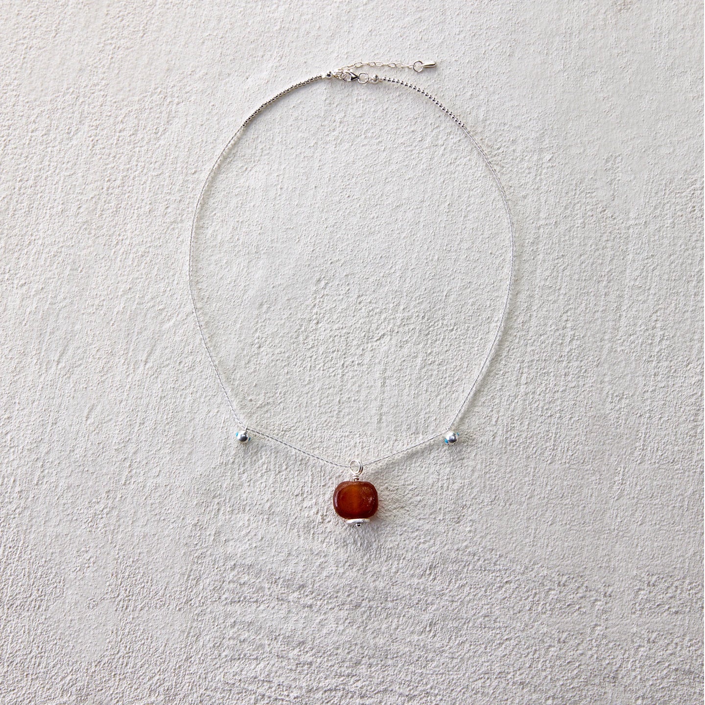 Minimalist necklace featuring red agate to inspire intention and vitality