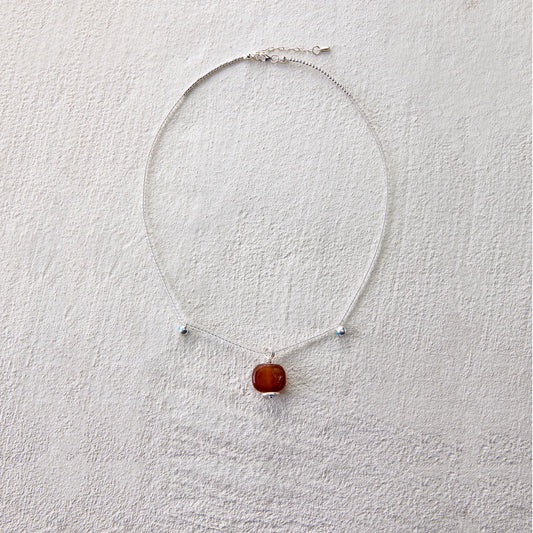 Minimalist necklace featuring red agate to inspire intention and vitality