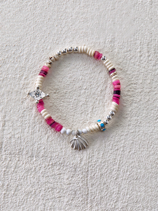 Handmade bracelet with shell beads, white turquoise, dyed shells, and silver shell charm