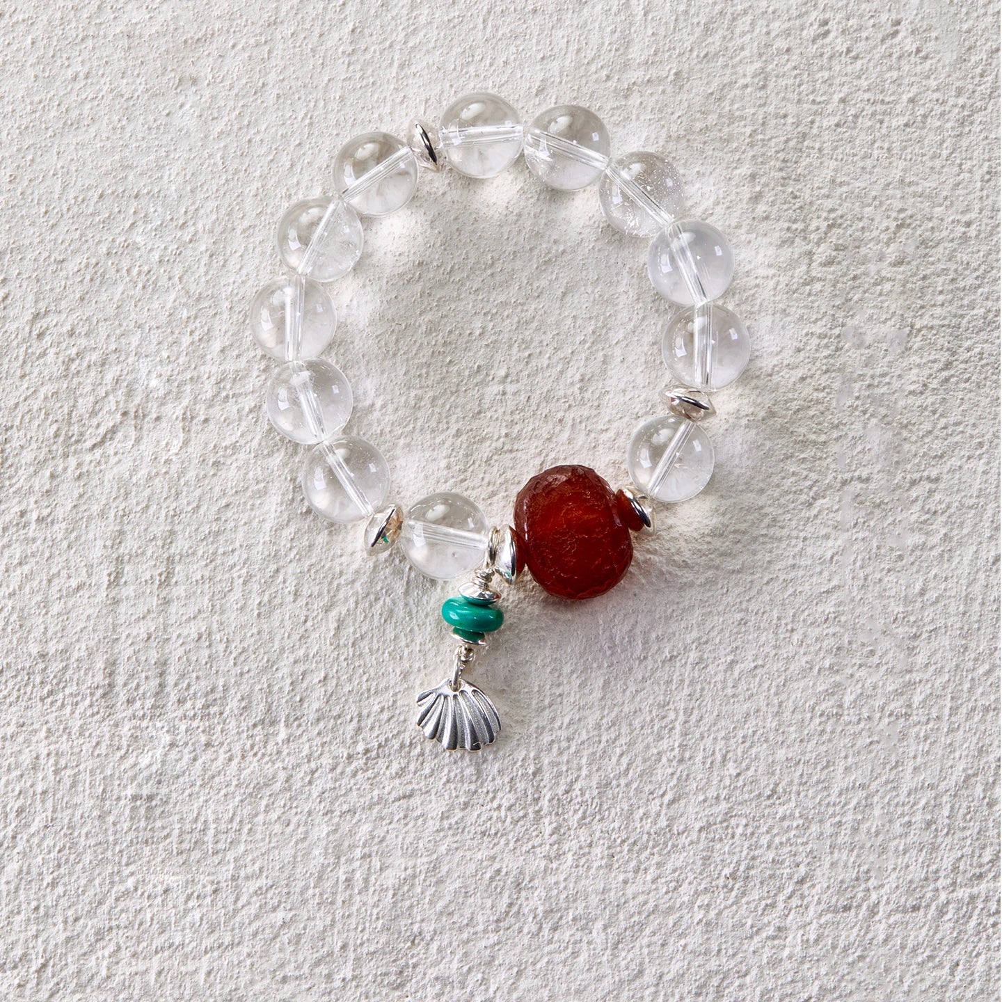 Bracelet with clear quartz beads, shell charm, carnelian and turquoise
