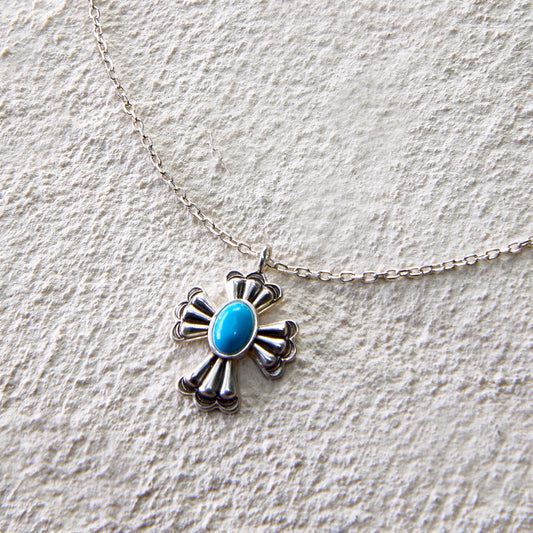 Silver cross pendant necklace with centered turquoise stone