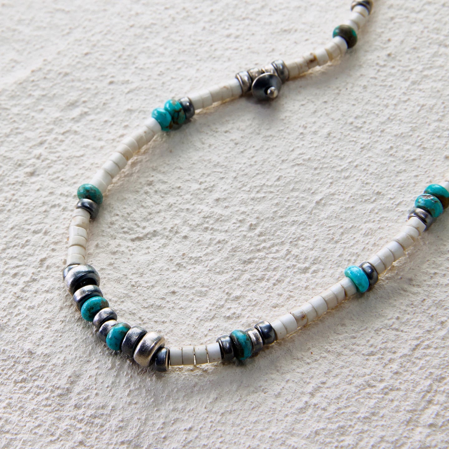 Delicate turquoise and silver necklace with layered tribal accents