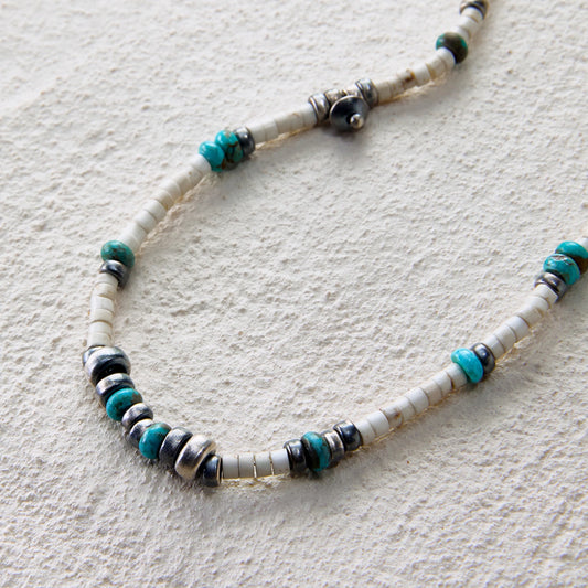 Delicate turquoise and silver necklace with layered tribal accents