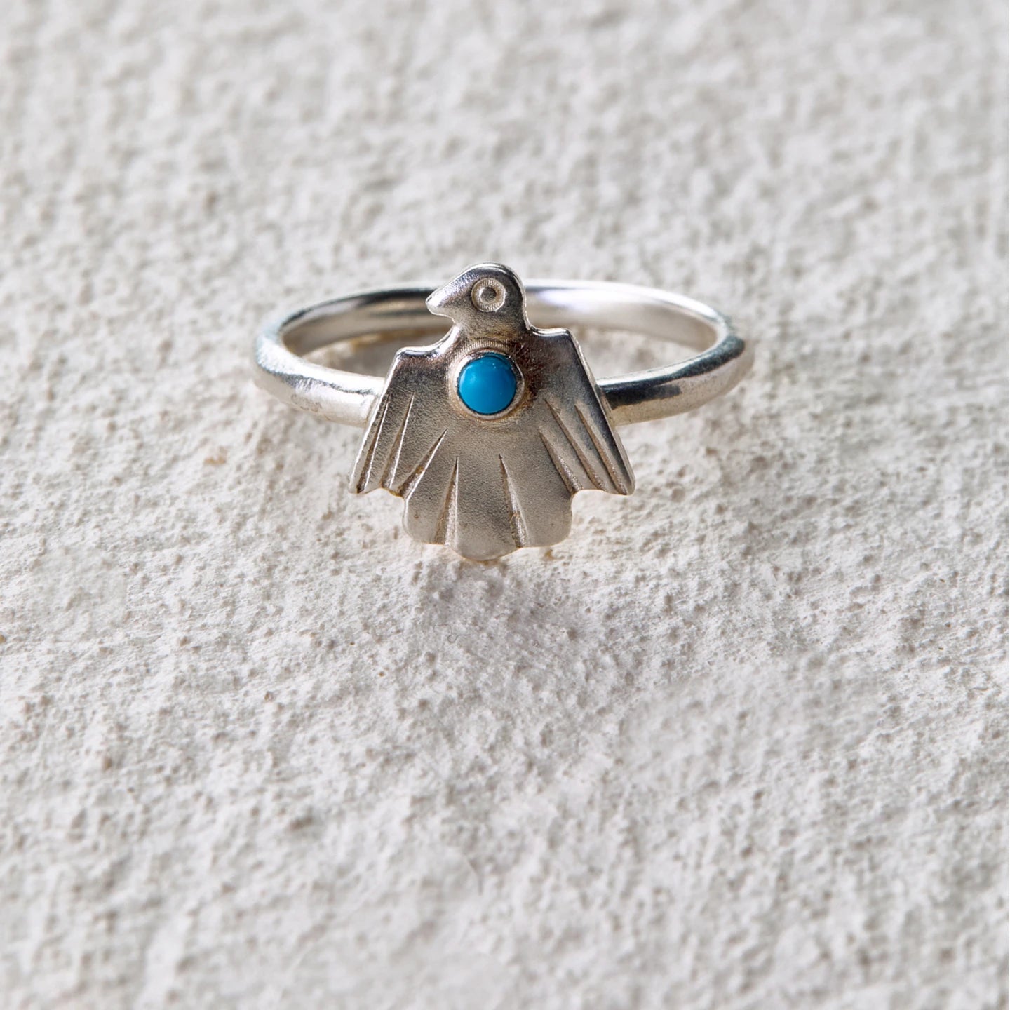 Carved spirit bird ring featuring turquoise, symbolizing protection and intuition