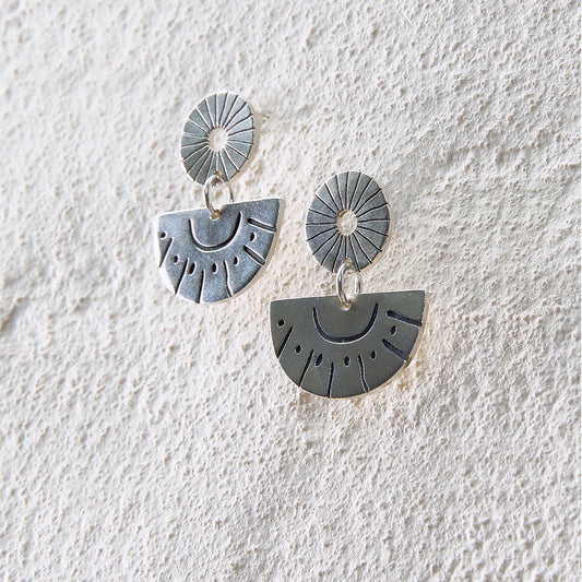 Silver drop earrings with sunburst engravings and half-circle sun motifs