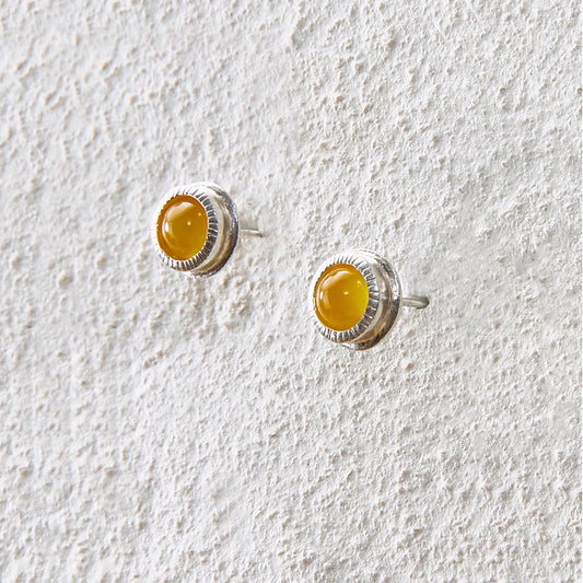 Round yellow agate stud earrings with detailed silver bezel setting
