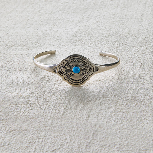 Totem-style open cuff with central turquoise inlay