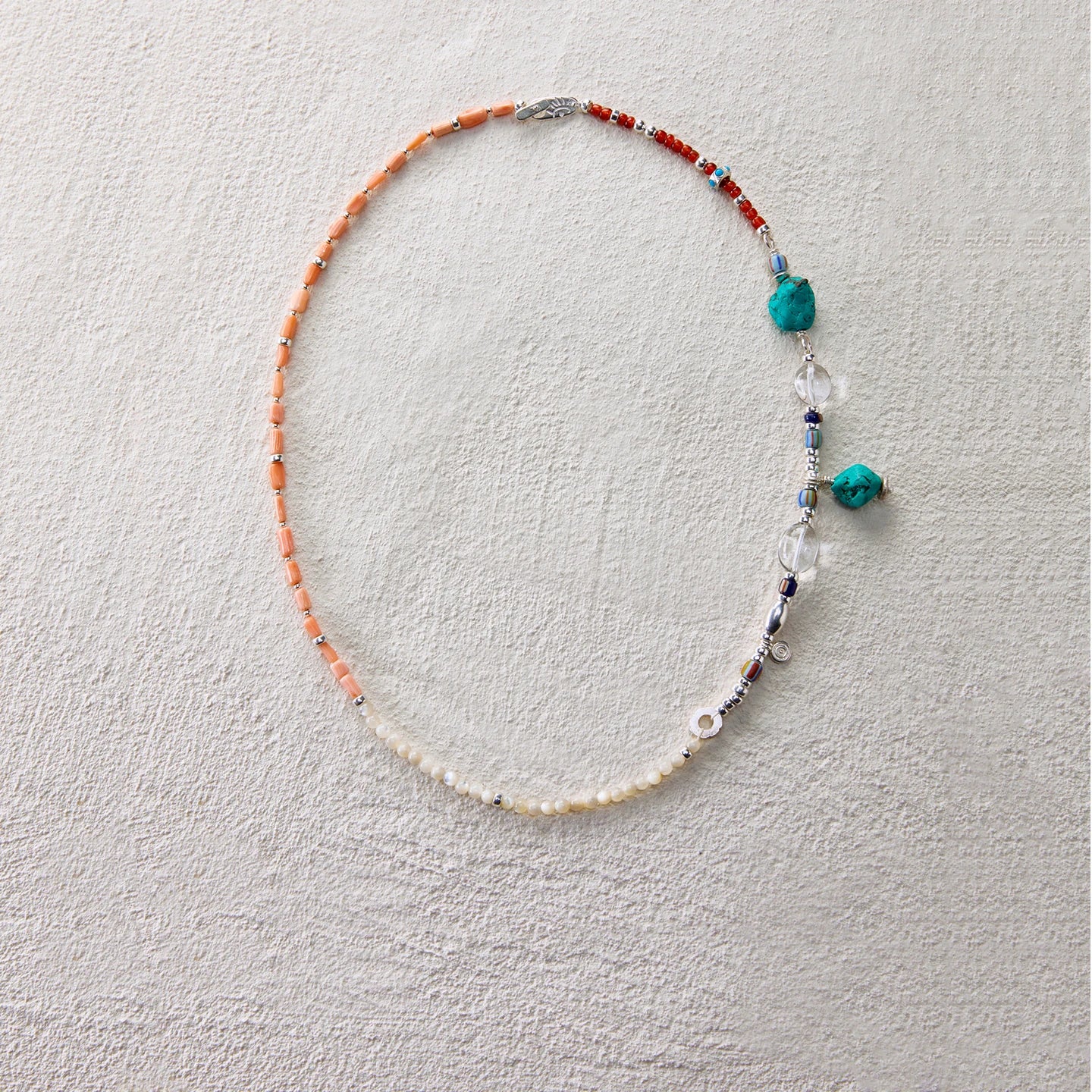 Colorful beaded necklace with sea coral, shell beads, and quartz, evoking a twilight glow