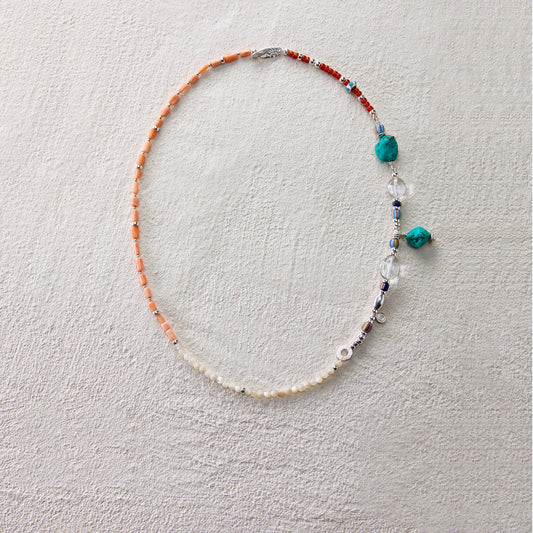Colorful beaded necklace with sea coral, shell beads, and quartz, evoking a twilight glow