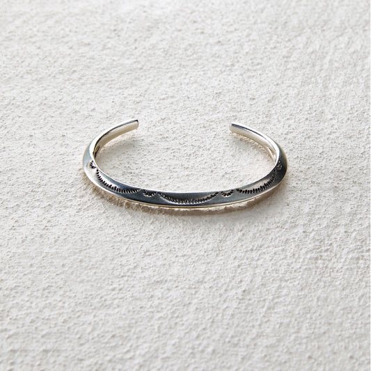 Sterling silver open cuff engraved with wave patterns