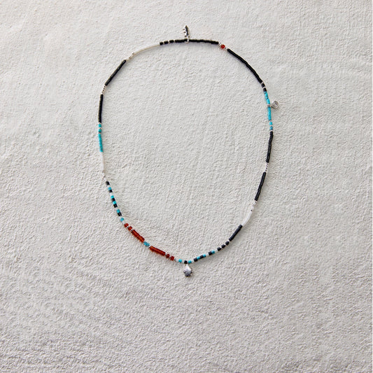 Ethnic beaded necklace made of black onyx, white jade, turquoise, and red agate
