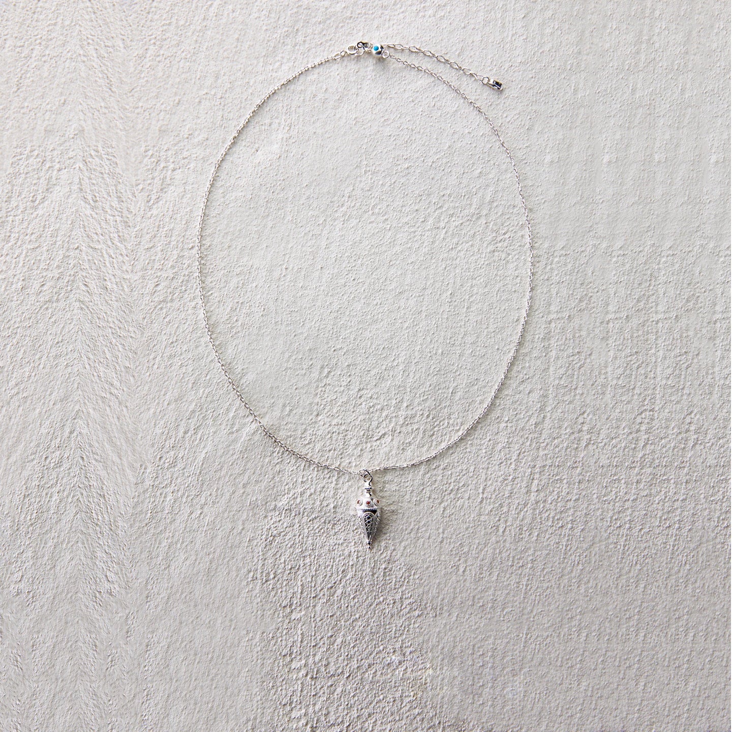 Elegant cone-shaped pendant necklace symbolizing protection and wishes