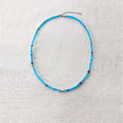 Blue glass beads with silver accents, creating a vibrant and breezy summer look