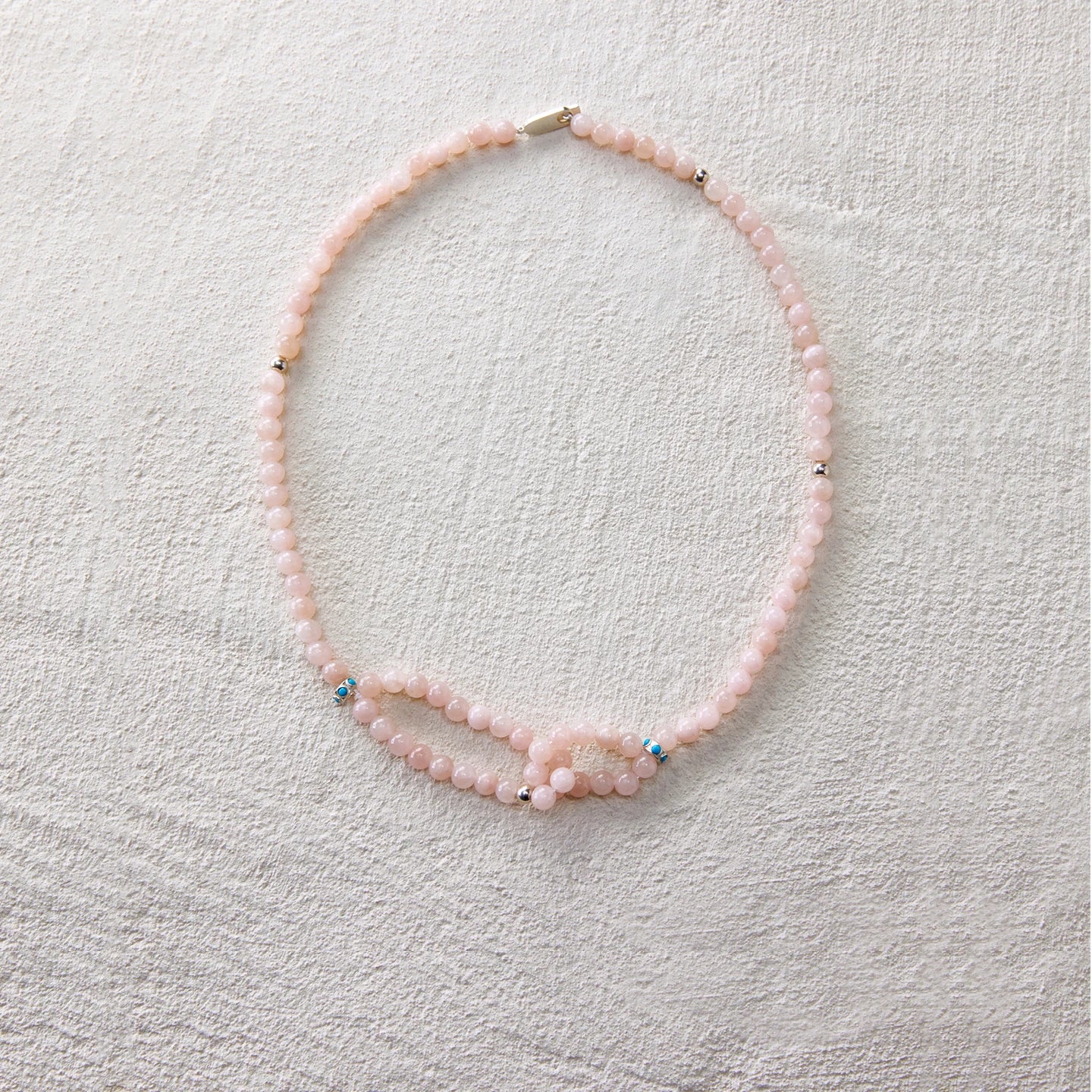 A gentle-toned necklace made of blush pink aventurine, radiating a soft and graceful charm