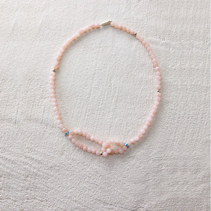 A gentle-toned necklace made of blush pink aventurine, radiating a soft and graceful charm