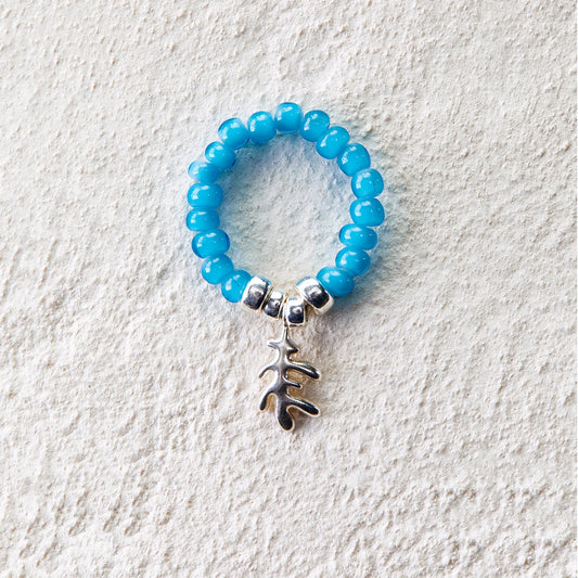 Elastic ring of blue glass beads with coral leaf pendant charm