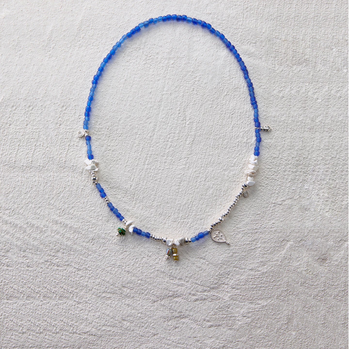 Deep blue glass bead necklace with turquoise and 925 silver charms, elegant and serene