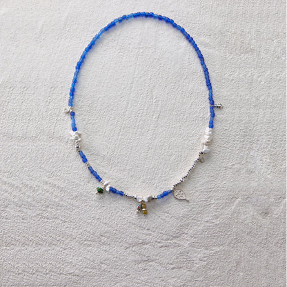 Deep blue glass bead necklace with turquoise and 925 silver charms, elegant and serene