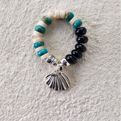Beaded ring with turquoise, white turquoise, black onyx, and silver seashell charm