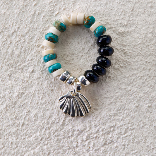 Beaded ring with turquoise, white turquoise, black onyx, and silver seashell charm