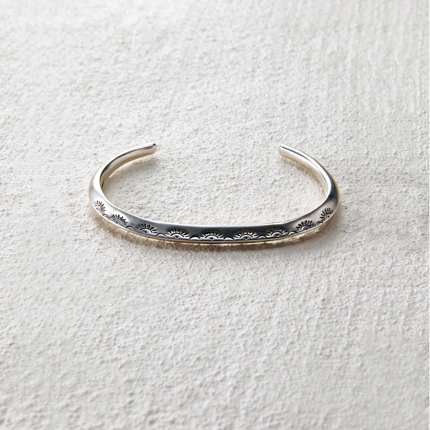 Minimal silver open cuff engraved with sunray patterns