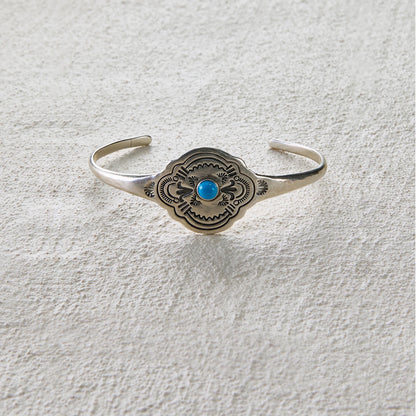 Totem-style open cuff with central turquoise inlay