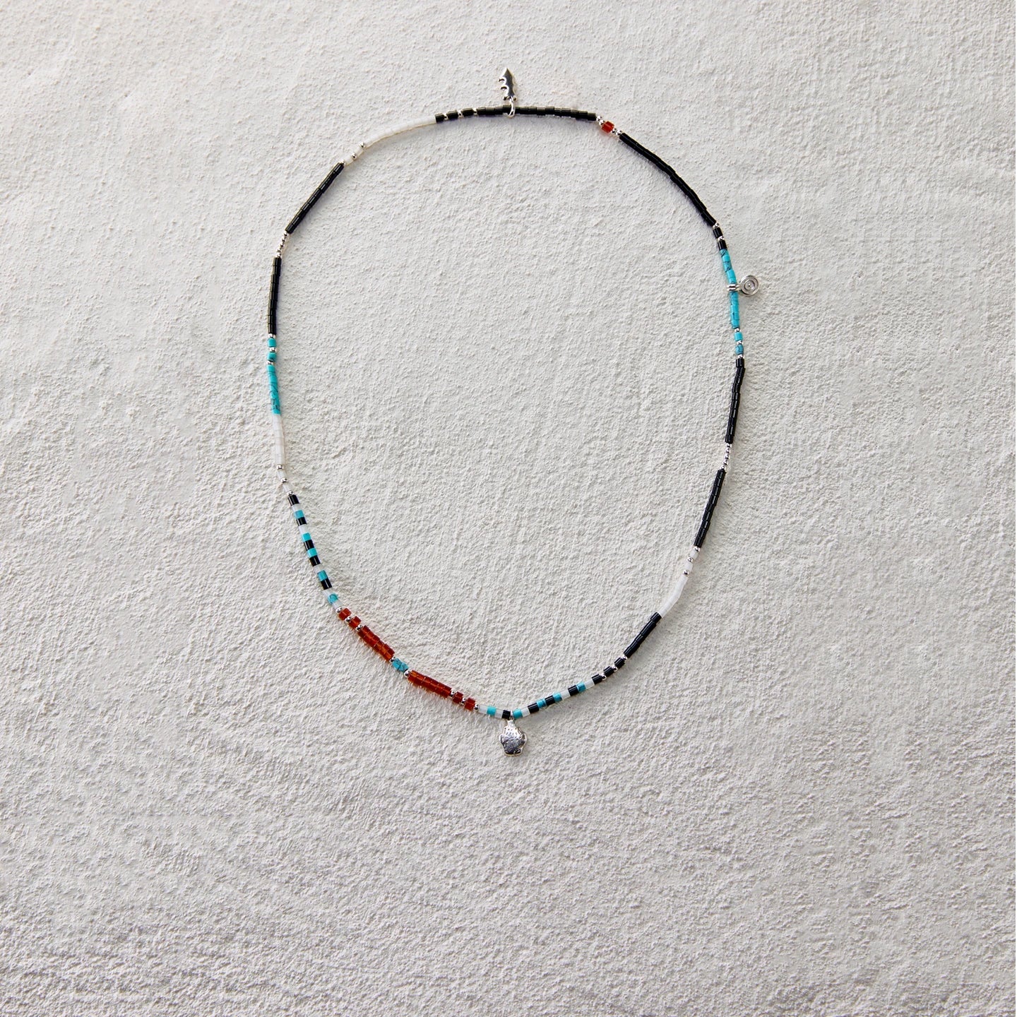 Ethnic beaded necklace made of black onyx, white jade, turquoise, and red agate