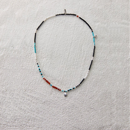 Ethnic beaded necklace made of black onyx, white jade, turquoise, and red agate