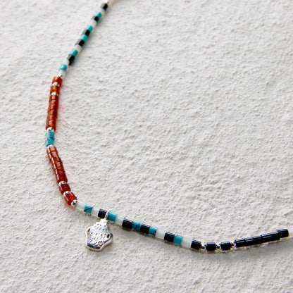 Ethnic beaded necklace made of black onyx, white jade, turquoise, and red agate