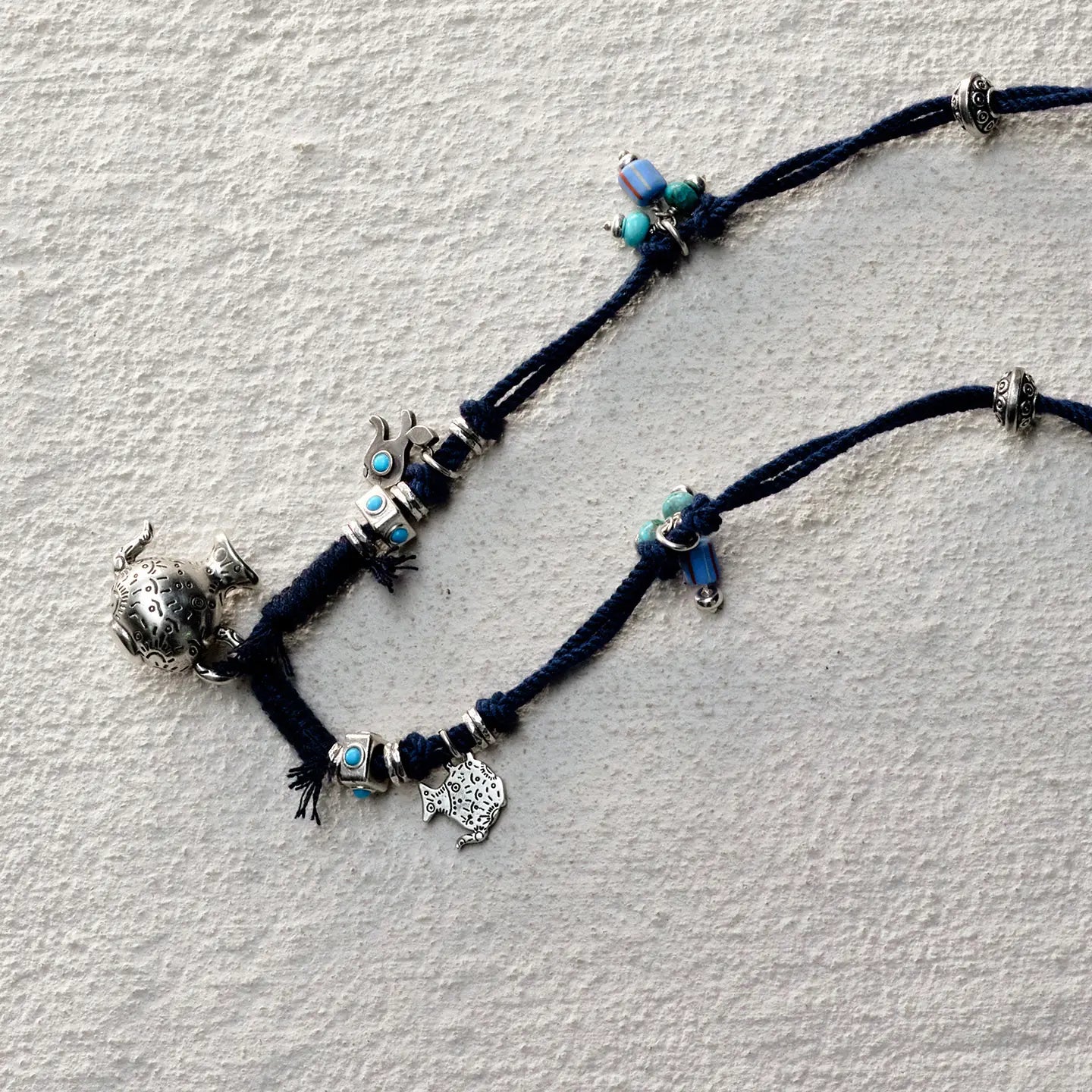ensage-tokyo-nomads-vessel-necklace-blue-braided-cotton-cord-silver-flask-pendant-turquoise-beads