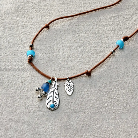 ensage-tokyo-whisper-of-the-wind-necklace-brown-waxed-cord-925-silver-feather-pendant-turquoise-blue-beads